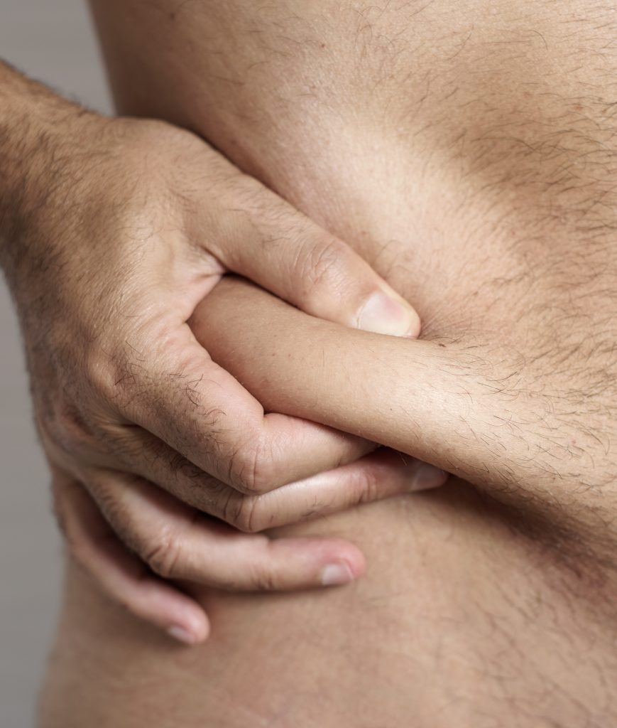 Man pinching his body fat