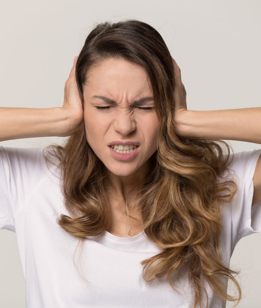 Frustrated woman with her hands on her head