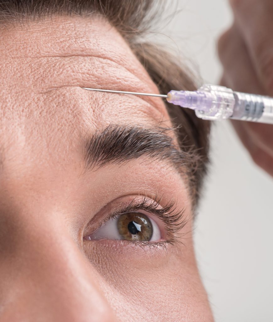 Man receiving a Botox injection in his forehead